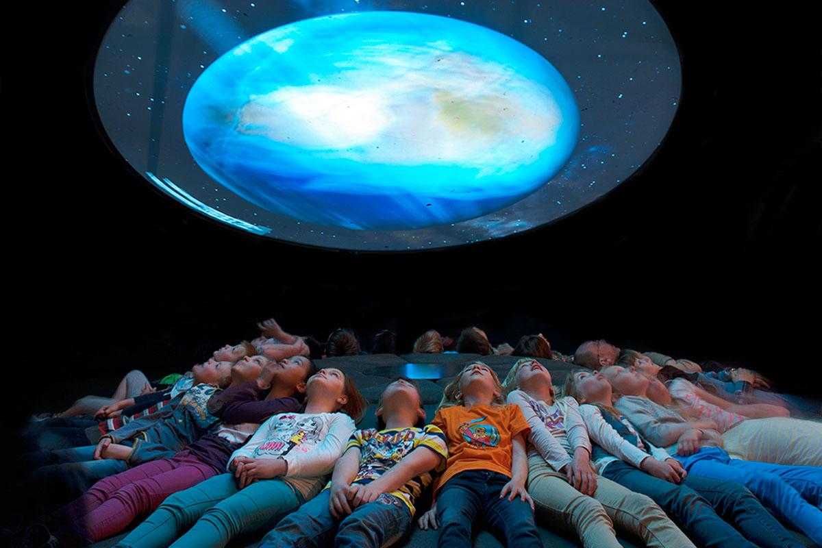 Visitors looking up at projection sky at Museum für Naturkunde Berlin